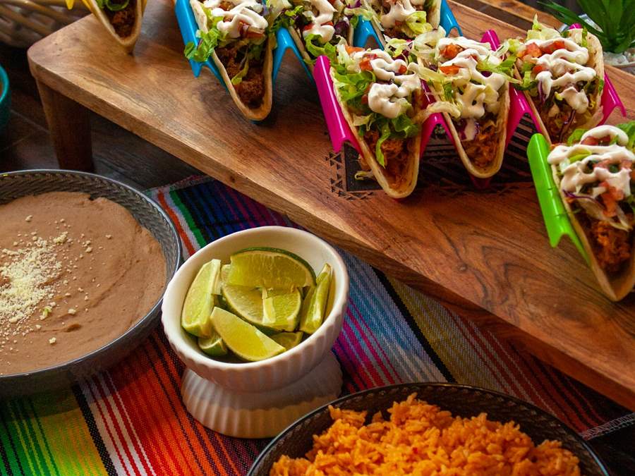 Assorted tacos, refried beans and Mexican rice for a catered event. 