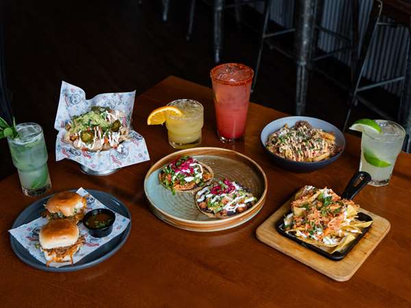 Skillet nachos, birra sliders, tostadas and more at Que Onda happy hour. 